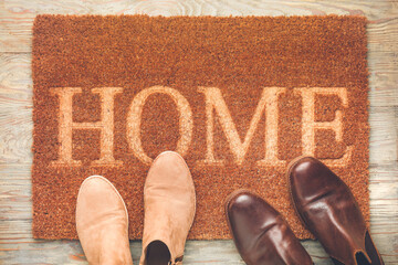 Door mat and shoes on floor