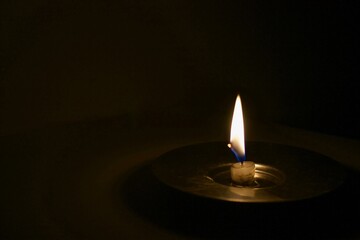 Burning candle in the dark