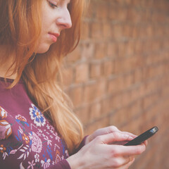 Close up young beautiful woman with smartphone. Media addiction. Psychological problems and media mania concept.