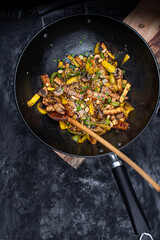 Vegan tofu, mushroom, pepper and squash stir fry in wok