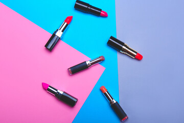 Set of lipsticks on color background