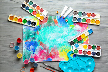 Set of artist's supplies on wooden background