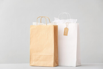 Paper shopping bags on light background