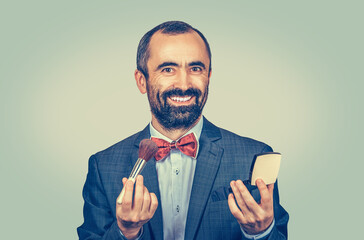 man holding brush and makeup compact powder smiling