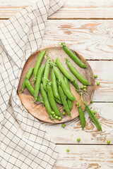 Plate with tasty fresh peas on table