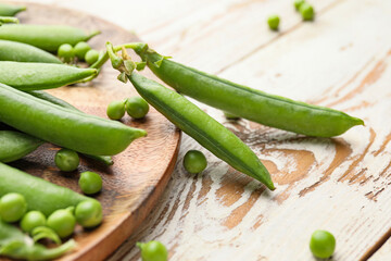 Plate with tasty fresh peas on table