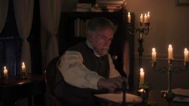man in the 18th century thinking and writing a letter