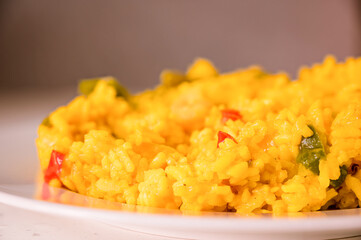 Typical Spanish food of rice with seafood, vegetables and saffron that gives it the characteristic yellow color known as paella