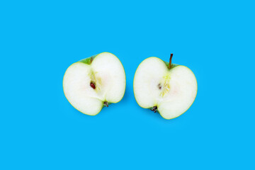 Fresh green apple on blue background.