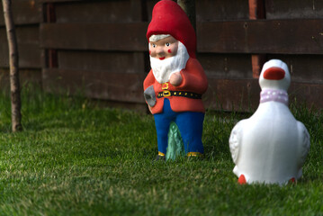 Garden dwarf in home garden. Gnome decoration.