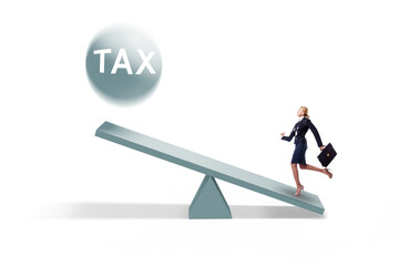 Businesswoman in tax concept with seesaw