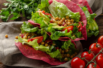 Vegan beetroot taco with salad, avocado, chickpea and vegetables