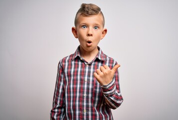 Young little caucasian kid with blue eyes wearing elegant shirt standing over isolated background...