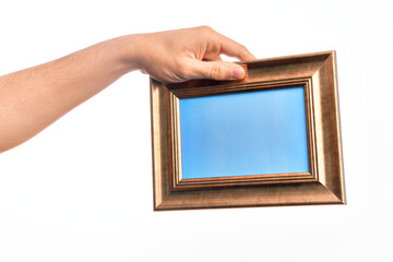 Hand of caucasian young man holding empty frame over isolated white background