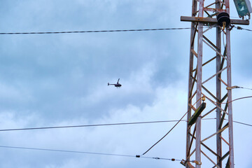 helicopter working on the power lines near color