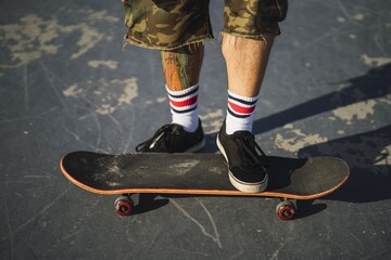 Young male doing different tricks with a skateboard in the park