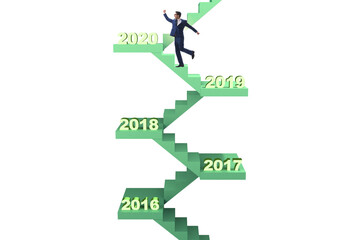 Businessman climbing stairs on yearly basis