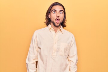 Young handsome man wearing business clothes afraid and shocked with surprise expression, fear and excited face.