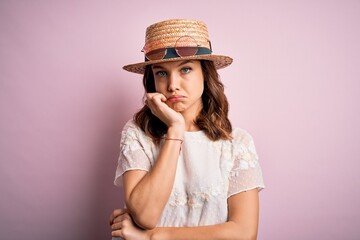 Young beautiful blonde girl wearing summer hat over pink isolated background thinking looking tired...