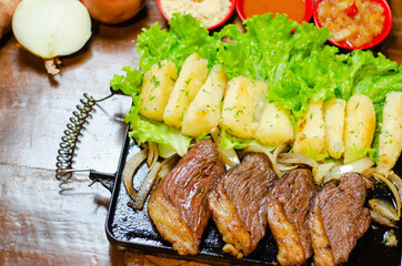porção de picanha com mandioca