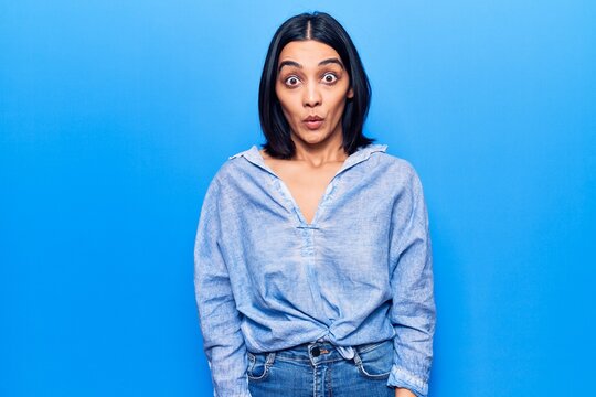 Young beautiful latin woman wearing casual clothes scared and amazed with open mouth for surprise, disbelief face