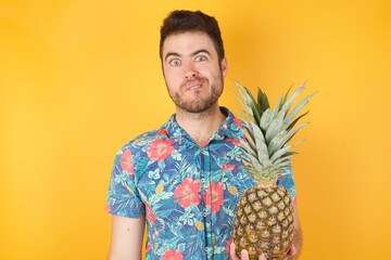 Handsome young man being nervous and scared biting lips looking camera with impatient expression,...