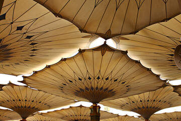 Canopies in Nabawi Mosque in Medina, Saudi Arabia.  Muslim pilgrims visiting the beautiful Nabawi...