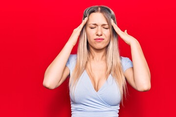 Young blonde woman wearing casual clothes with hand on head, headache because stress. suffering migraine.