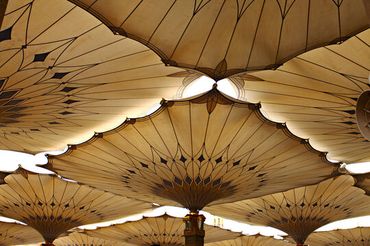 Canopies in Nabawi Mosque in Medina, Saudi Arabia.  Muslim pilgrims visiting the beautiful Nabawi Mosque, the Prophet mosque which has great architecture during hajj and umrah season.