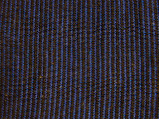 Close-up view of striped blue and black fabric with visible lint