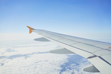 Fototapeta premium Cloudscape from window airplane, landscape of wing plane on a cloudy sky