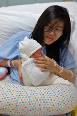mother parenting, mom using hand help a baby newborn belch burping after breastfeeding milk
