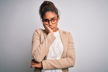 Beautiful african american businesswoman wearing jacket and glasses over white background thinking looking tired and bored with depression problems with crossed arms.