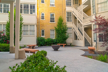 Fire pit and stone benches outside a multi storey residential building complex