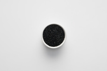 Black sesame seeds on white bowl