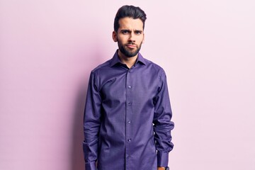 Young handsome man with beard wearing casual shirt skeptic and nervous, frowning upset because of problem. negative person.
