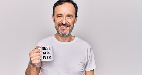 Middle age handsome man drinking cup of coffee with best dad ever message looking positive and...