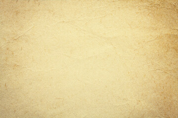 Texture of beige old paper, crumpled background. Vintage sand grunge surface backdrop.