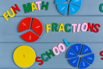 Close up mathematical fractions and colorful letters on gray background. Creative, fun mathematics...