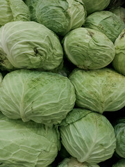 Fototapeta na wymiar Stacked cabbage for sale.