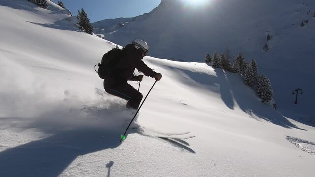 Freeride skiing in good conditions and best style. Professional offpist skiing and very smooth filming in sixty frames per second. The mountains look big and the snow is nice and cold.