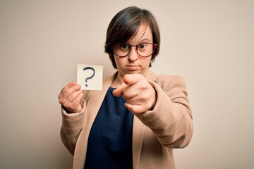 Young down syndrome business woman holding question mark paper as doubt symbol pointing with finger...