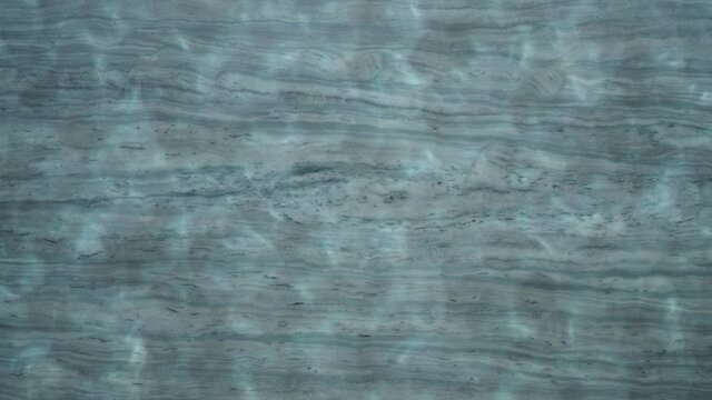Gray Marble On The Floor Under The Rippling Water - close up