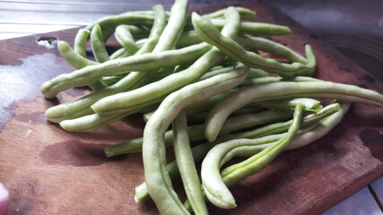 Washed Green Beans ready for cut at kitchen work top.