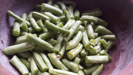 Chopped Green Beans in clay pot.