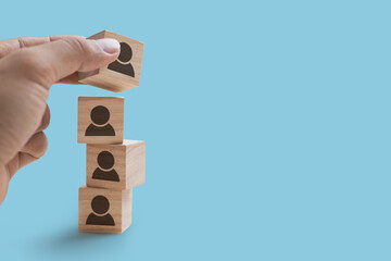 Close up of hand is stacking wooden blocks icons people, Strategy concept and the copy space on...