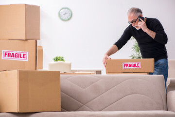 Fototapeta premium Old male professional mover doing home relocation