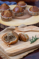 Piece of homemade Banana cake on wooden board with rosemary for snack