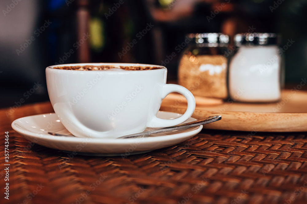 Wall mural cup of coffee on table in the morning at cafe.