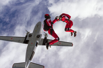 Two sports parachutist build a figure in free fall. Extreme sport concept.